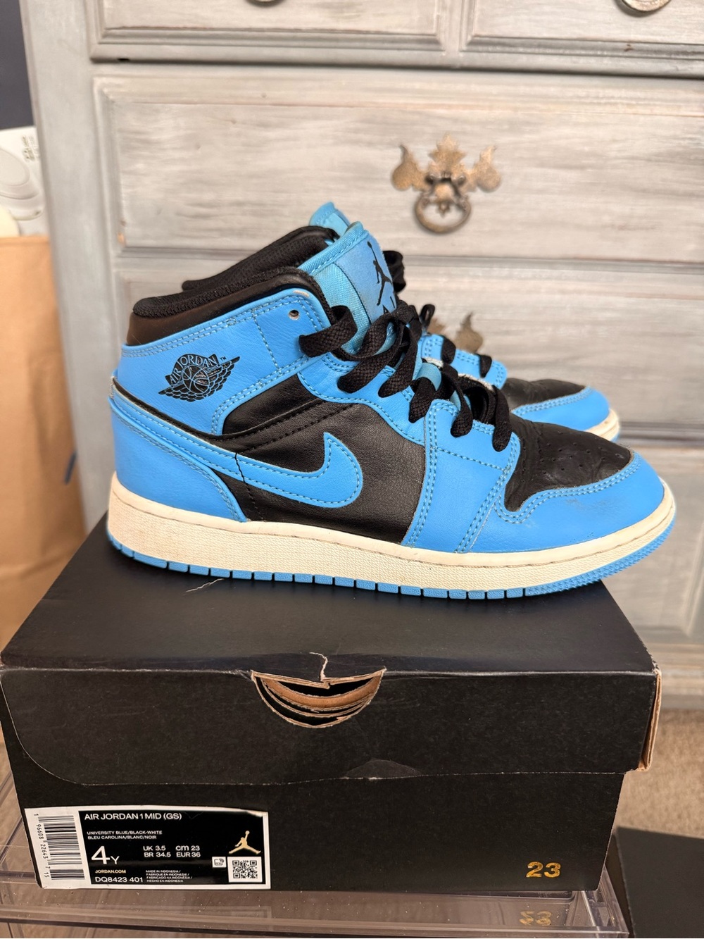 Jordan Retro Mid Top Sneakers in Black and University Blue